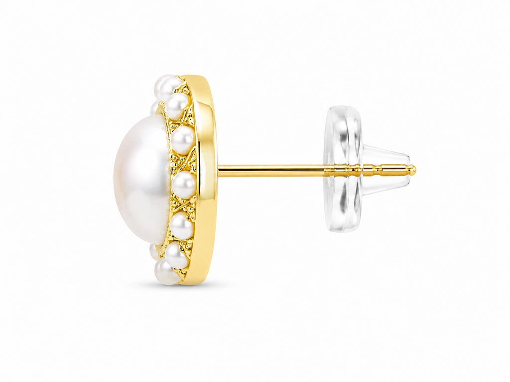 Gold earring with pearls on a white background