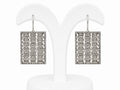 Pair of square earrings with intricate design on a white background
