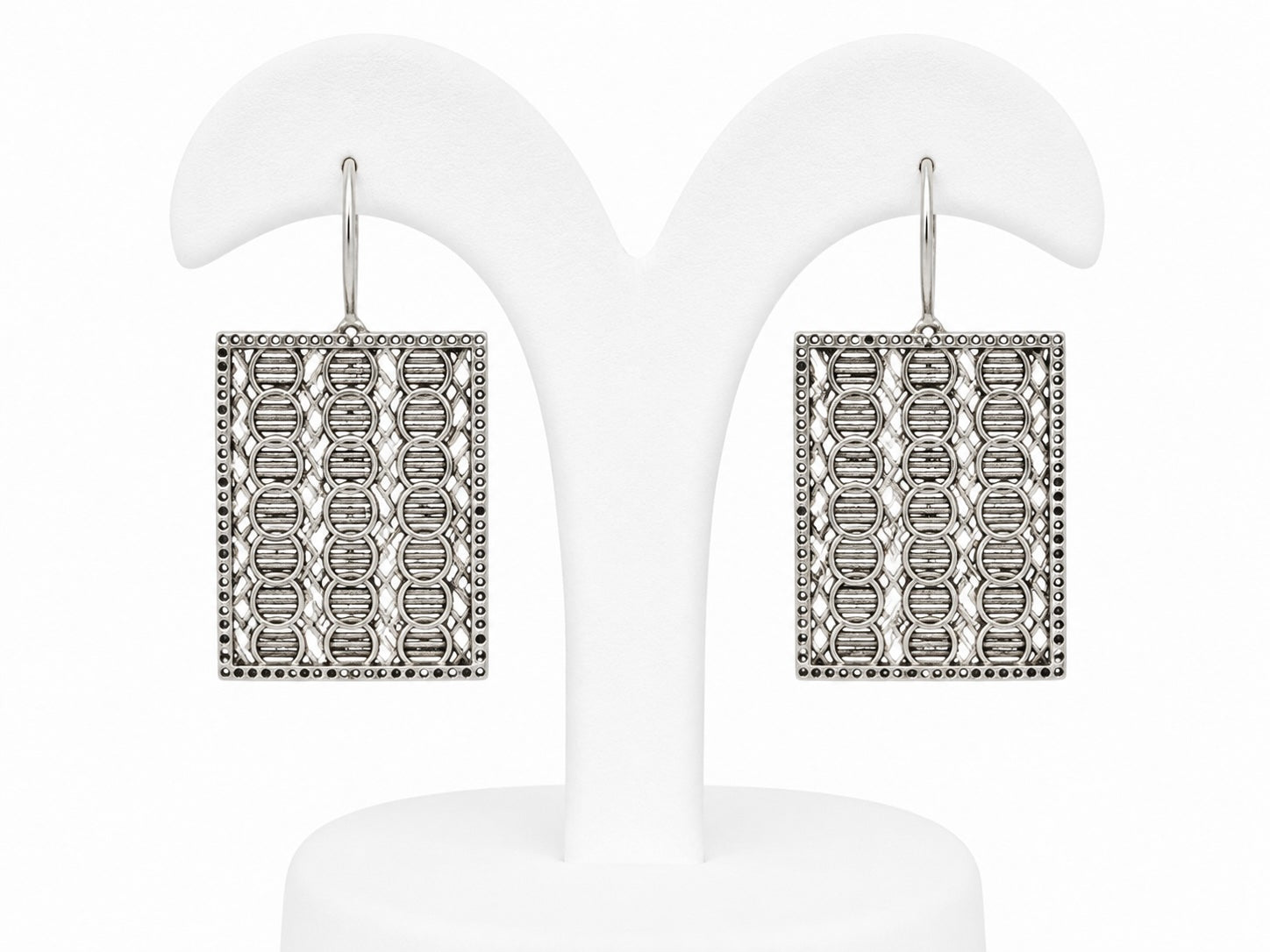 Pair of square earrings with intricate design on a white background