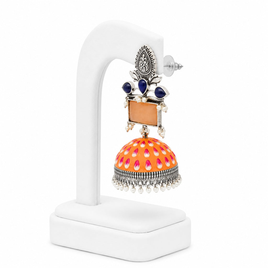 Decorative earrings on a white stand with a white background