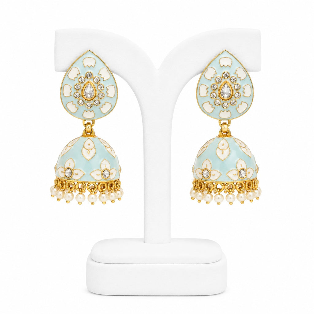 Decorative earrings on a white stand with a light blue and gold design.
