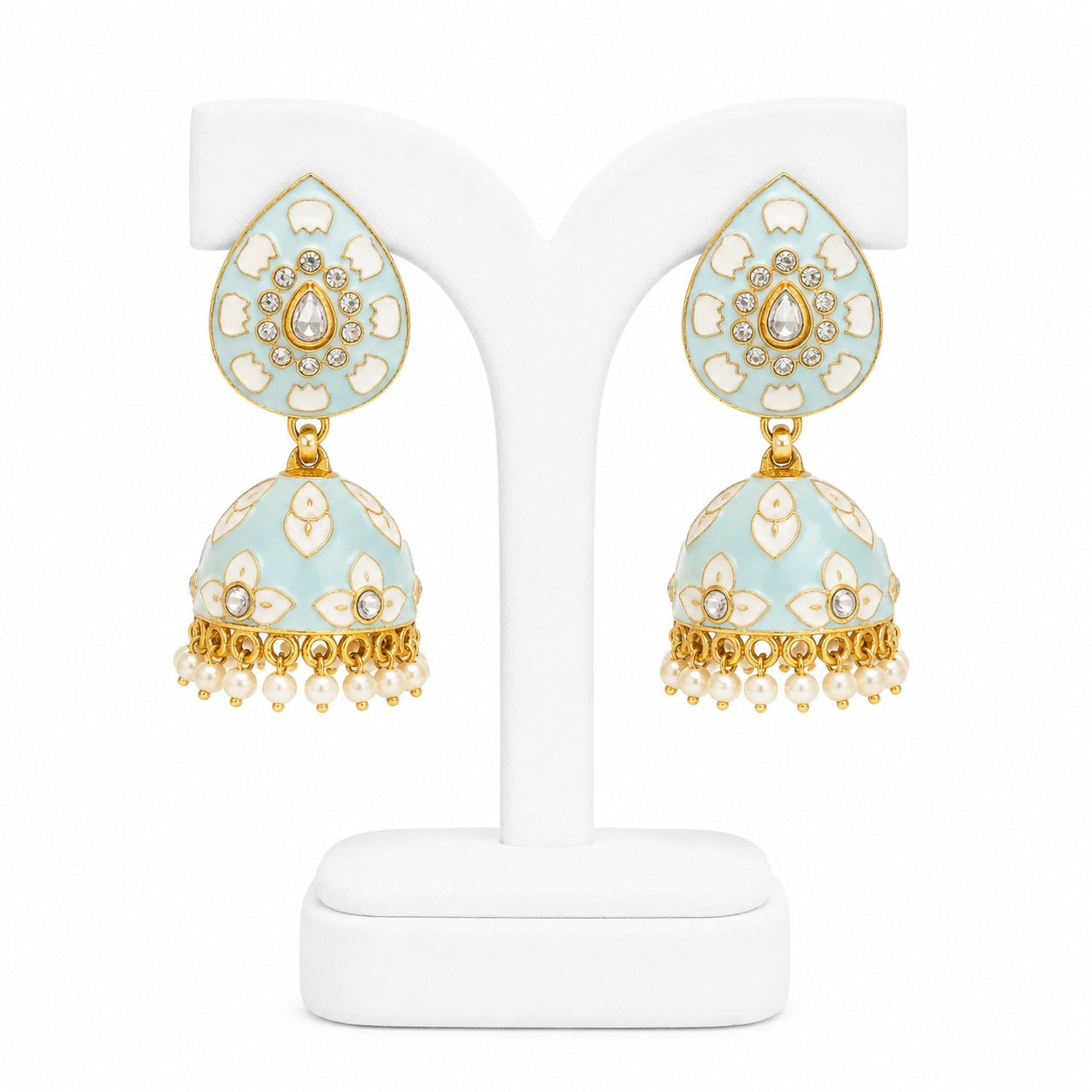Decorative earrings on a white stand with a light blue and gold design.