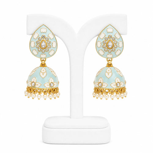 Decorative earrings on a white stand with a light blue and gold design.