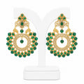 Gold and green earrings on a white stand