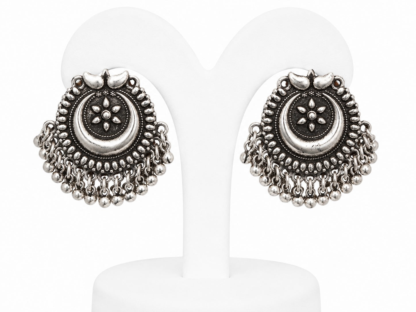 Pair of silver earrings on a white background