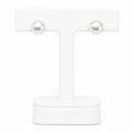 Pair of pearl earrings on a white stand with a white background