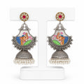 Decorative earrings with intricate designs on a white background