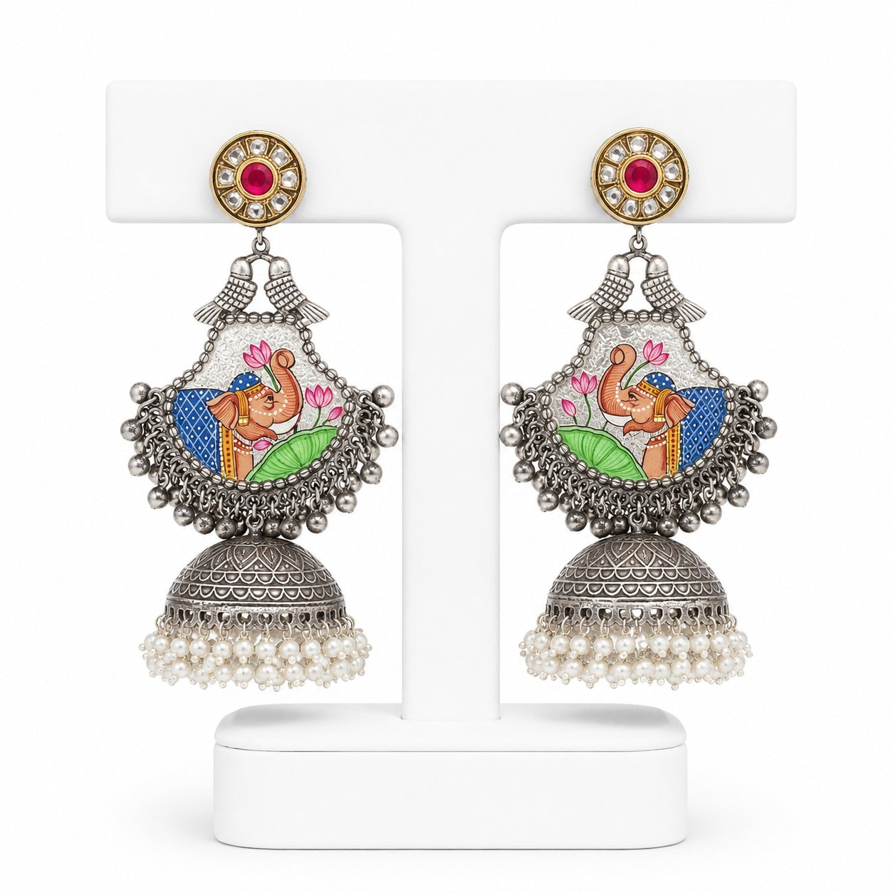 Decorative earrings with intricate designs on a white background