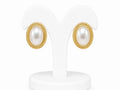 Pair of pearl earrings with gold accents on a white stand.
