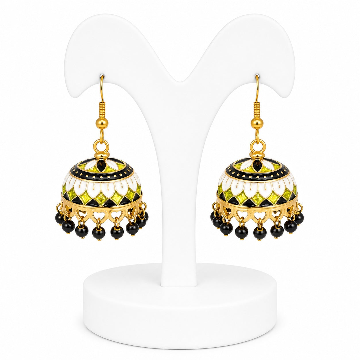 Pair of gold, black, and green earrings on a white stand