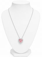Necklace with a pink heart-shaped pendant on a white mannequin bust.
