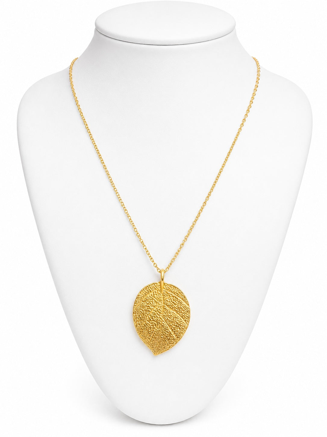 Gold leaf pendant necklace on a white mannequin bust