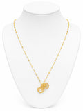 Gold necklace with a pendant on a white mannequin bust
