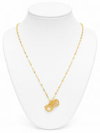 Gold necklace with a pendant on a white mannequin bust