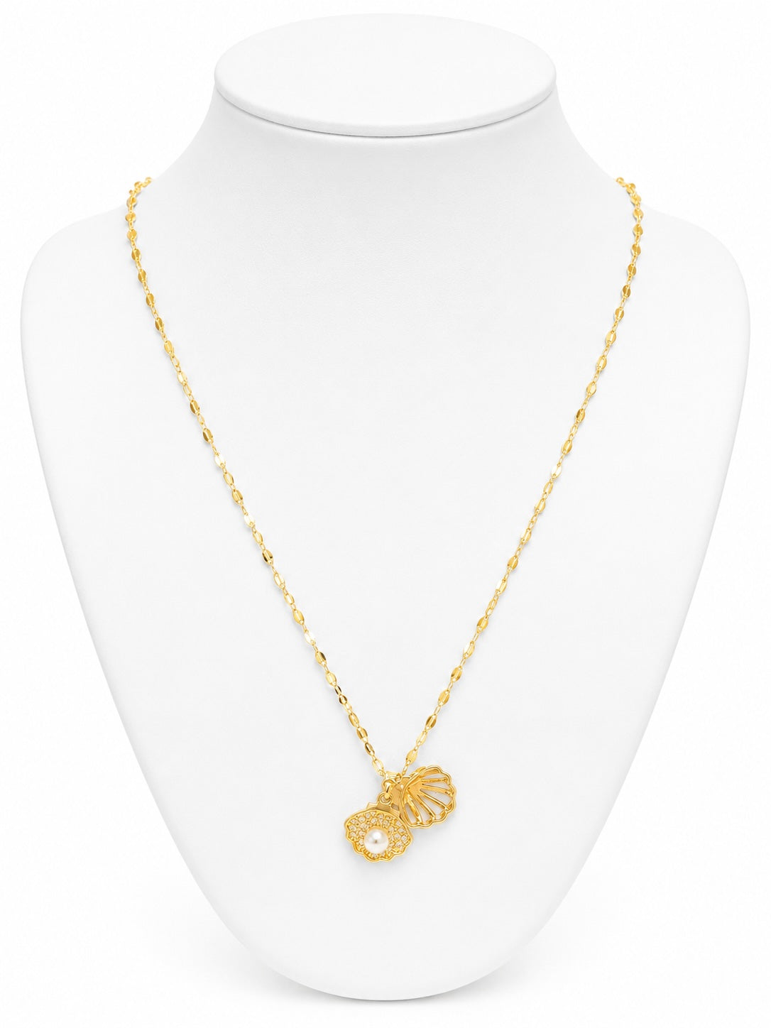 Gold necklace with a pendant on a white mannequin bust