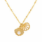 Gold necklace with shell and pearl pendant on a white background