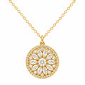Gold necklace with a round, diamond-studded pendant on a white background