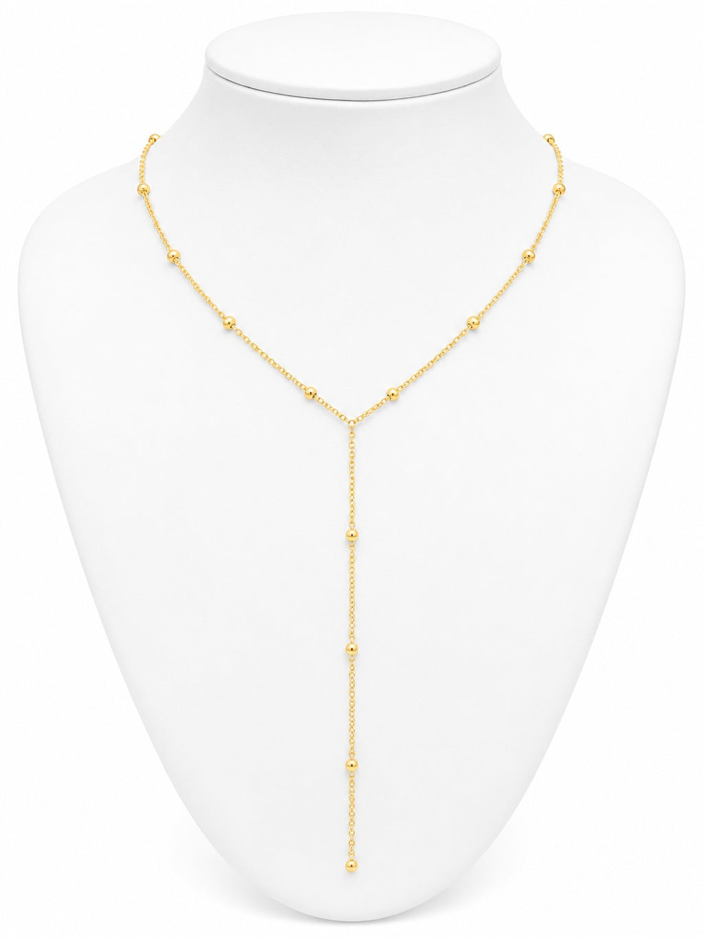 Gold necklace on a white mannequin bust