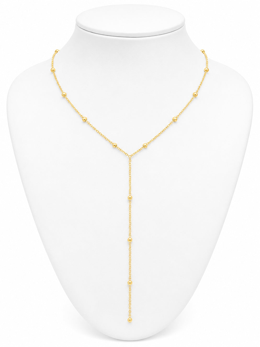 Gold necklace on a white mannequin bust