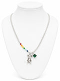 Necklace with colorful beads and a teddy bear pendant on a white mannequin.