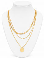 Gold chain necklace on a white mannequin bust