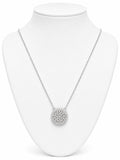 Silver necklace with a round pendant on a white mannequin bust.