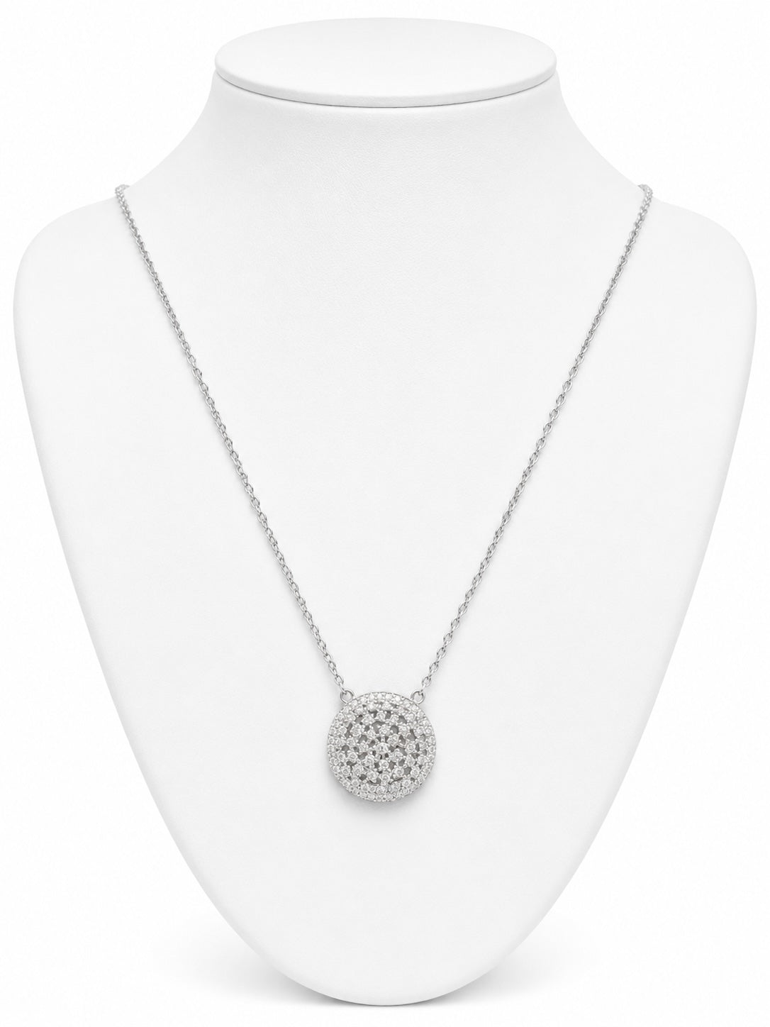 Silver necklace with a round pendant on a white mannequin bust.