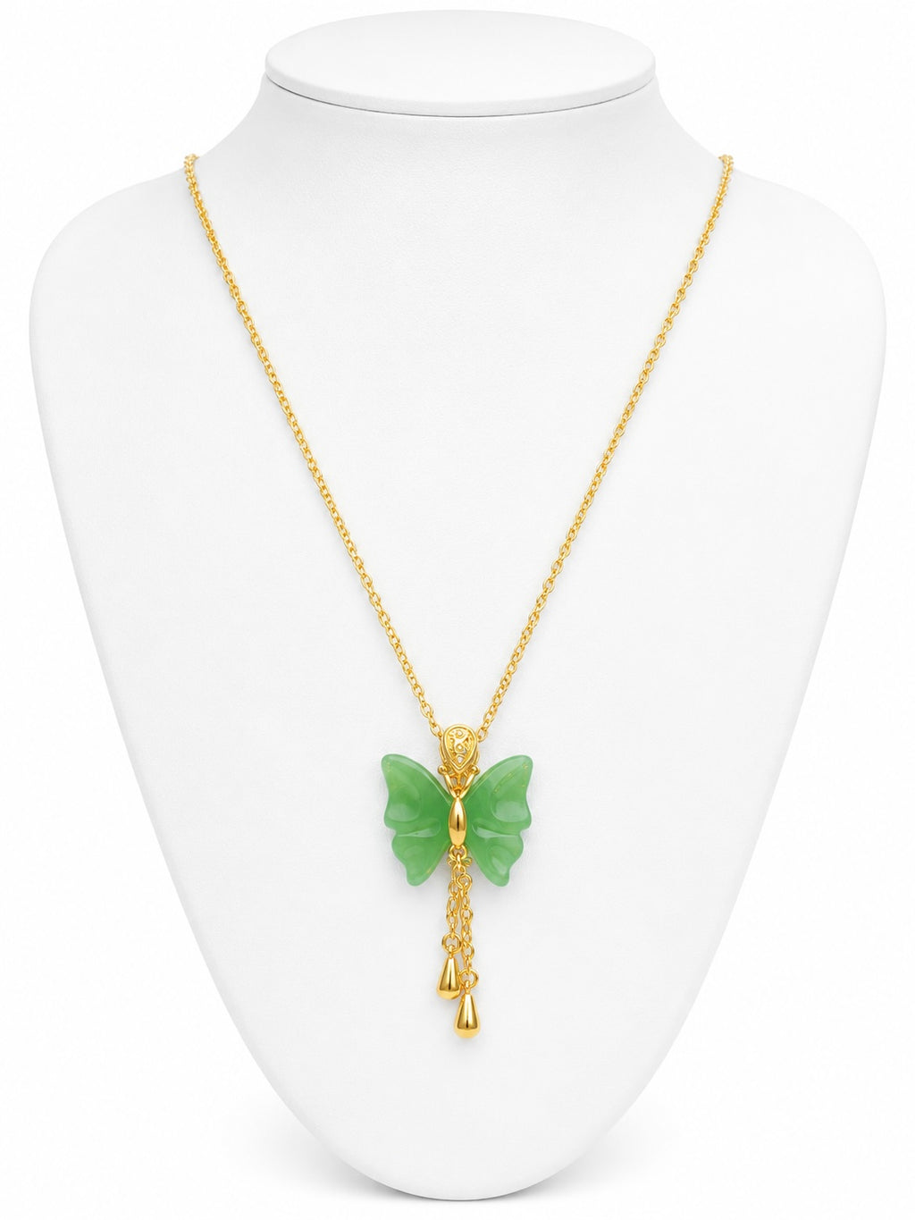 Gold necklace with a green butterfly pendant on a white mannequin bust.