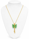 Gold necklace with a green butterfly pendant on a white mannequin bust.
