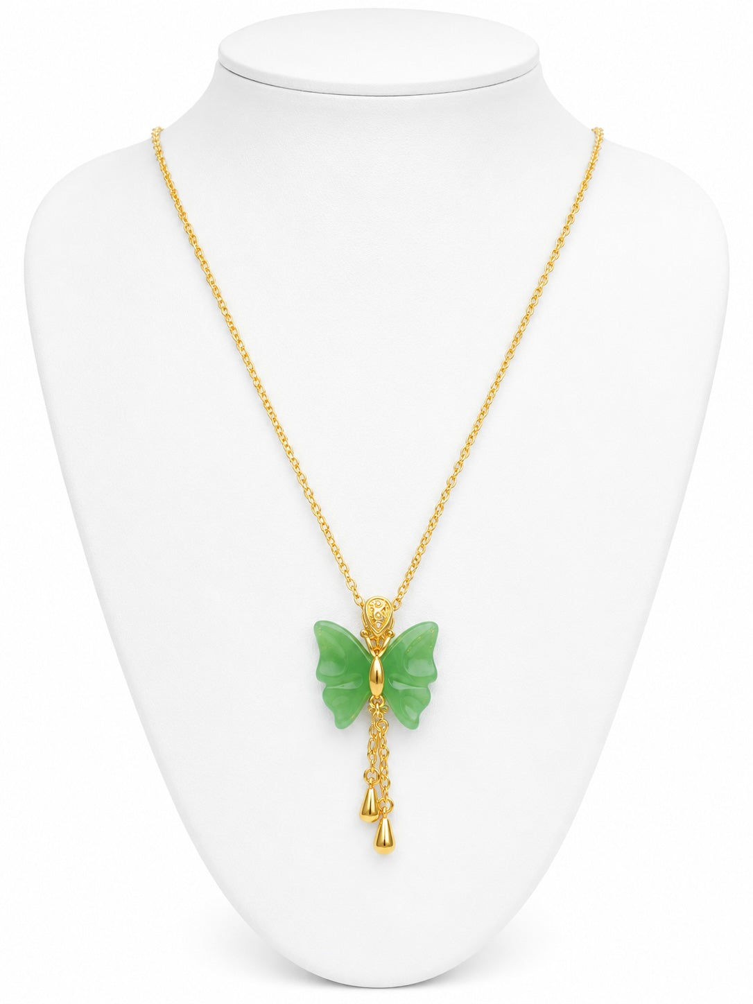 Gold necklace with a green butterfly pendant on a white mannequin bust.