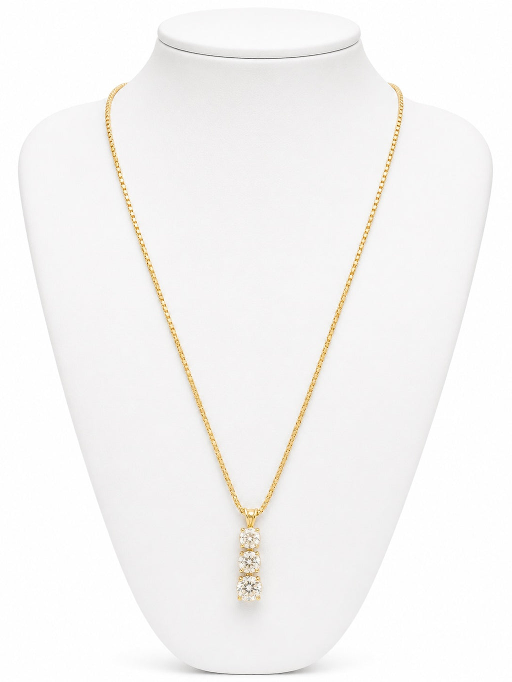 Gold necklace with a pendant on a white mannequin bust