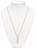 Gold necklace with a pendant on a white mannequin bust