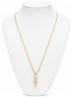 Gold necklace with a pendant on a white mannequin bust