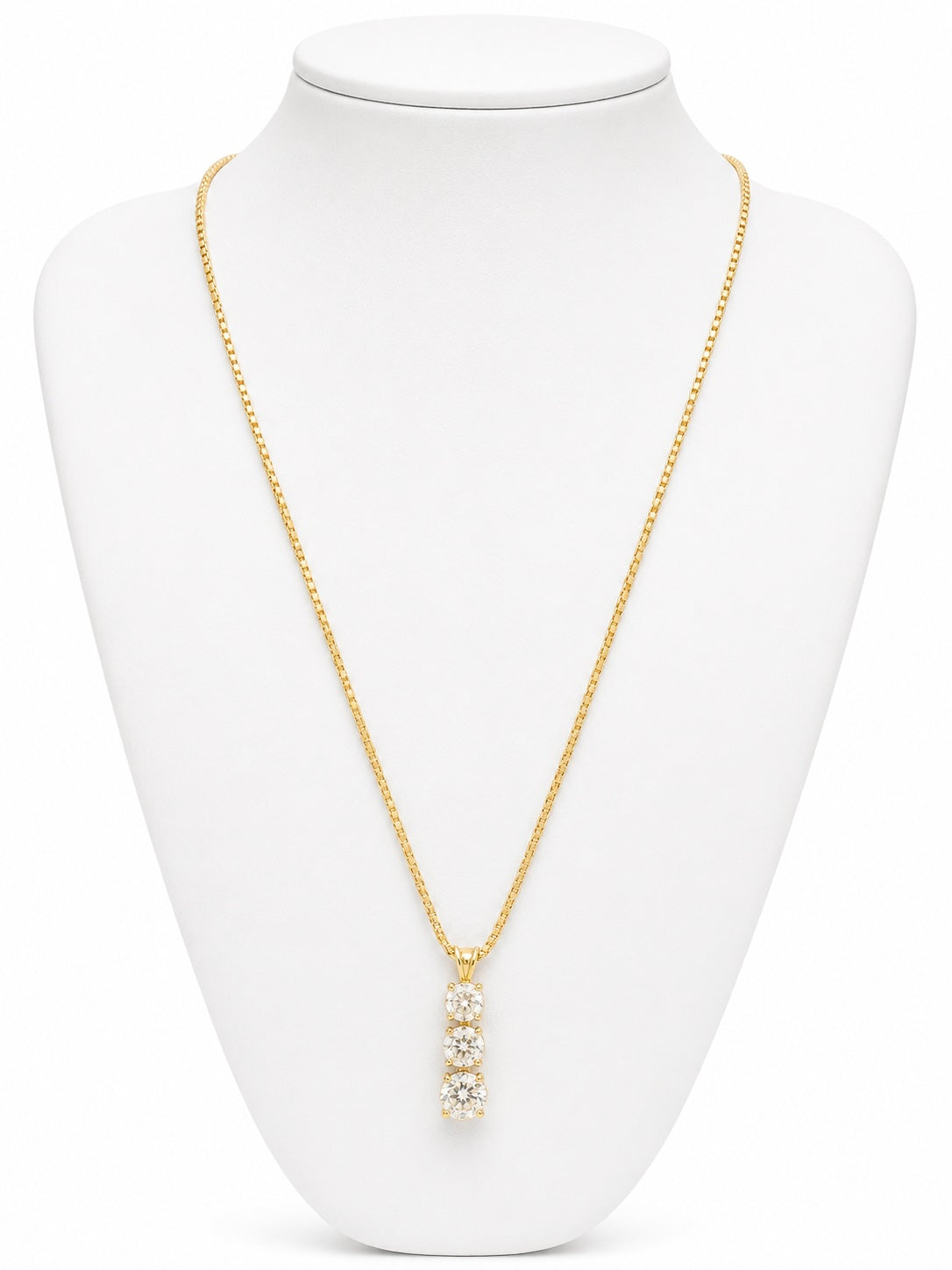 Gold necklace with a pendant on a white mannequin bust