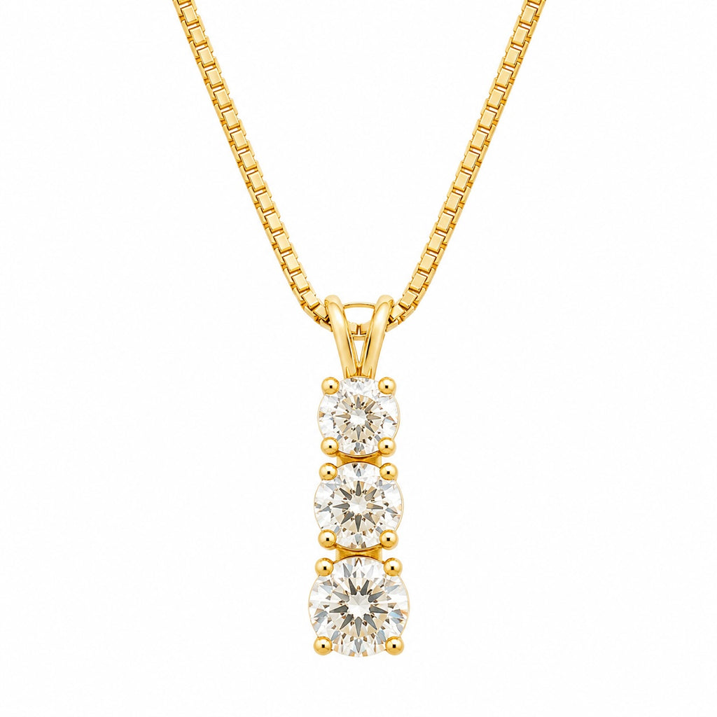 Gold necklace with three diamond pendants on a white background
