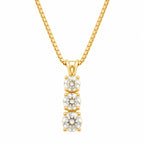 Gold necklace with three diamond pendants on a white background