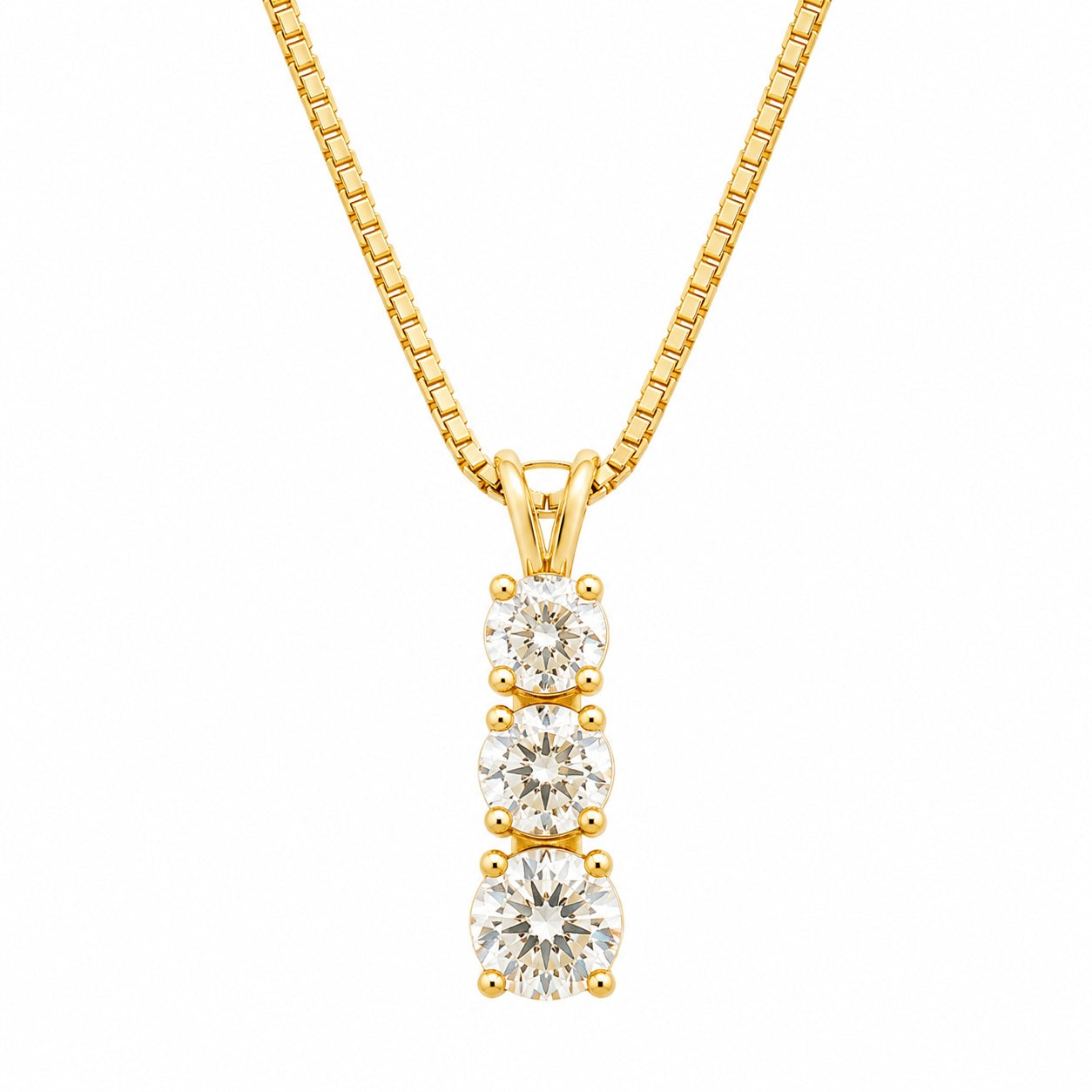 Gold necklace with three diamond pendants on a white background