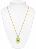 Gold necklace with a green teardrop pendant on a white mannequin bust.