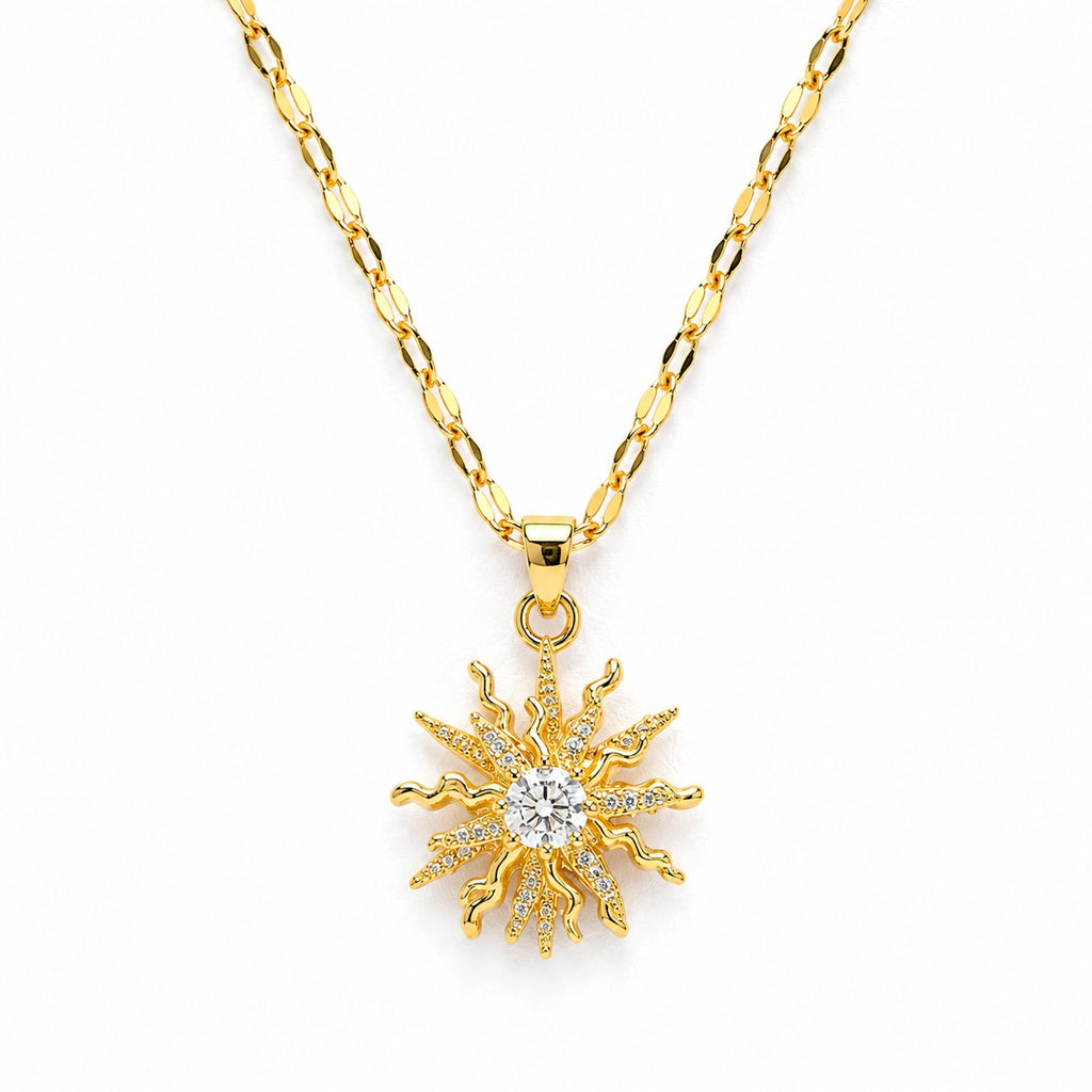 Gold sun-shaped pendant necklace on a white background