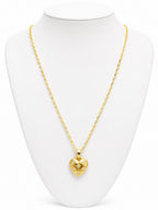 Gold heart-shaped necklace on a white mannequin bust