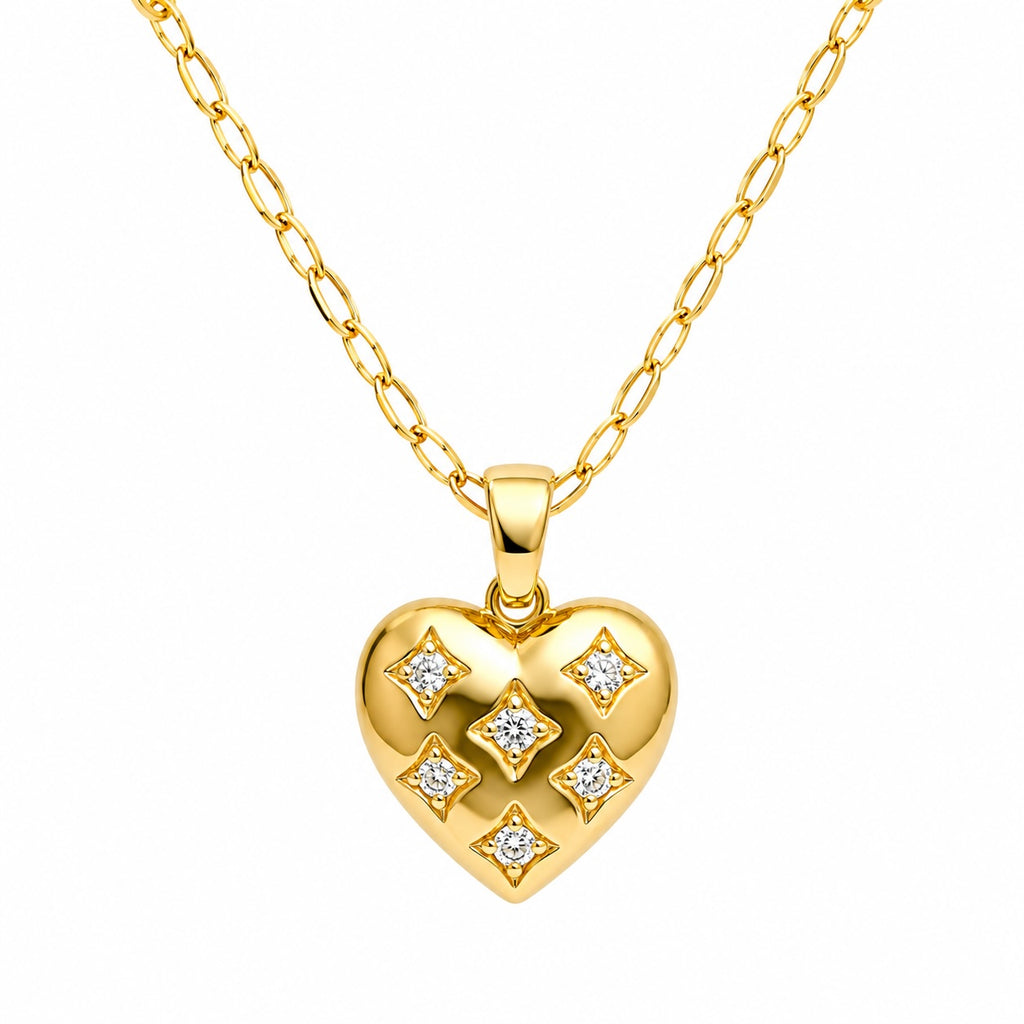 Gold heart-shaped pendant with diamond accents on a gold chain against a white background
