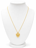 Gold heart-shaped necklace on a white mannequin 