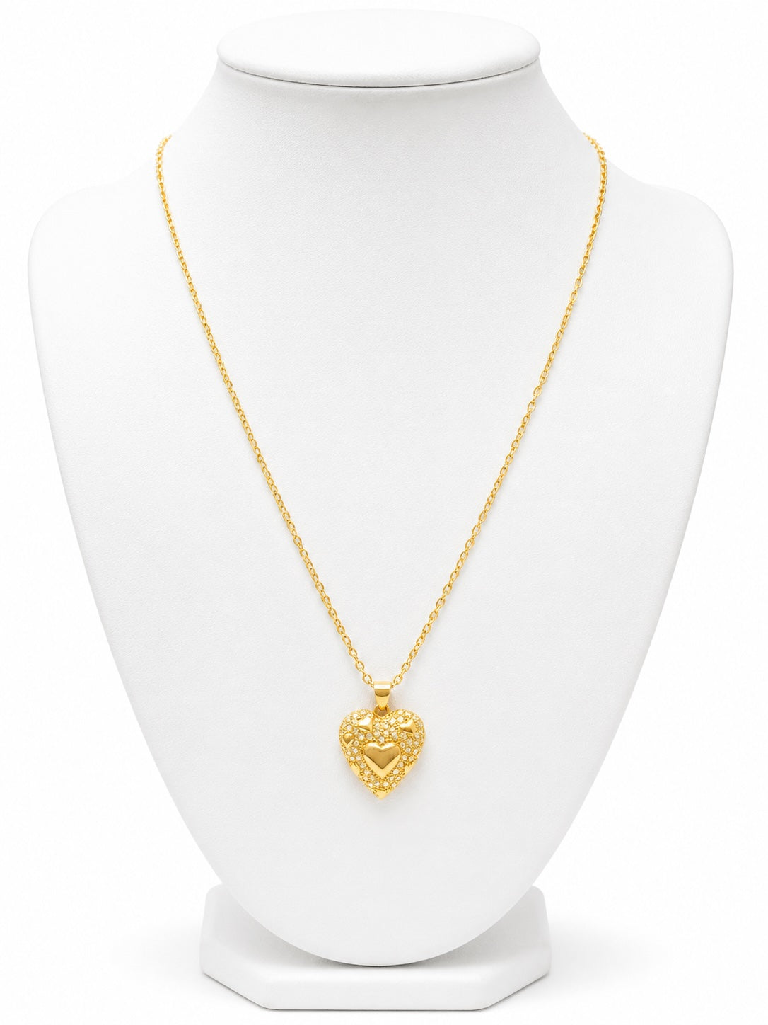 Gold heart-shaped necklace on a white mannequin 
