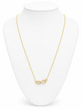 Gold infinity necklace on a white bust