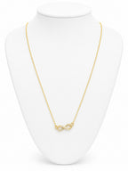 Gold infinity necklace on a white bust