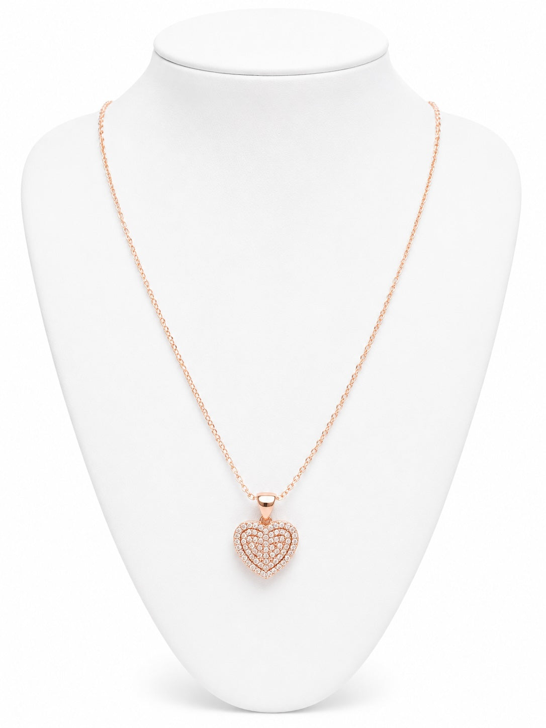 Rose gold heart-shaped necklace on a white mannequin bust