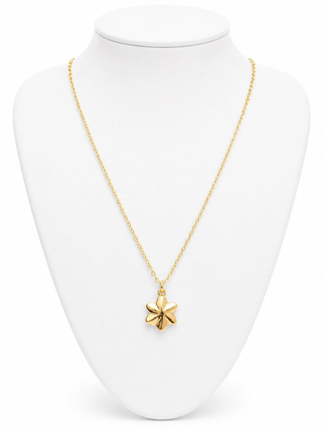 Gold necklace with a star pendant on a white mannequin bust