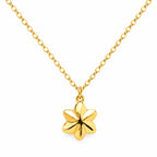 Gold necklace with a flower pendant on a white background