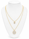 Gold necklace with circular pendants on a white mannequin bust