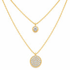 Two gold necklaces with round pendants on a white background